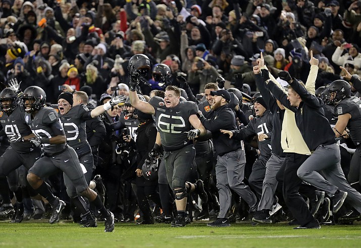 Army players and coaches run onto the field after winning defeating Navy 21-17 in an NCAA college football game in Baltimore, Saturday, Dec. 10, 2016. 