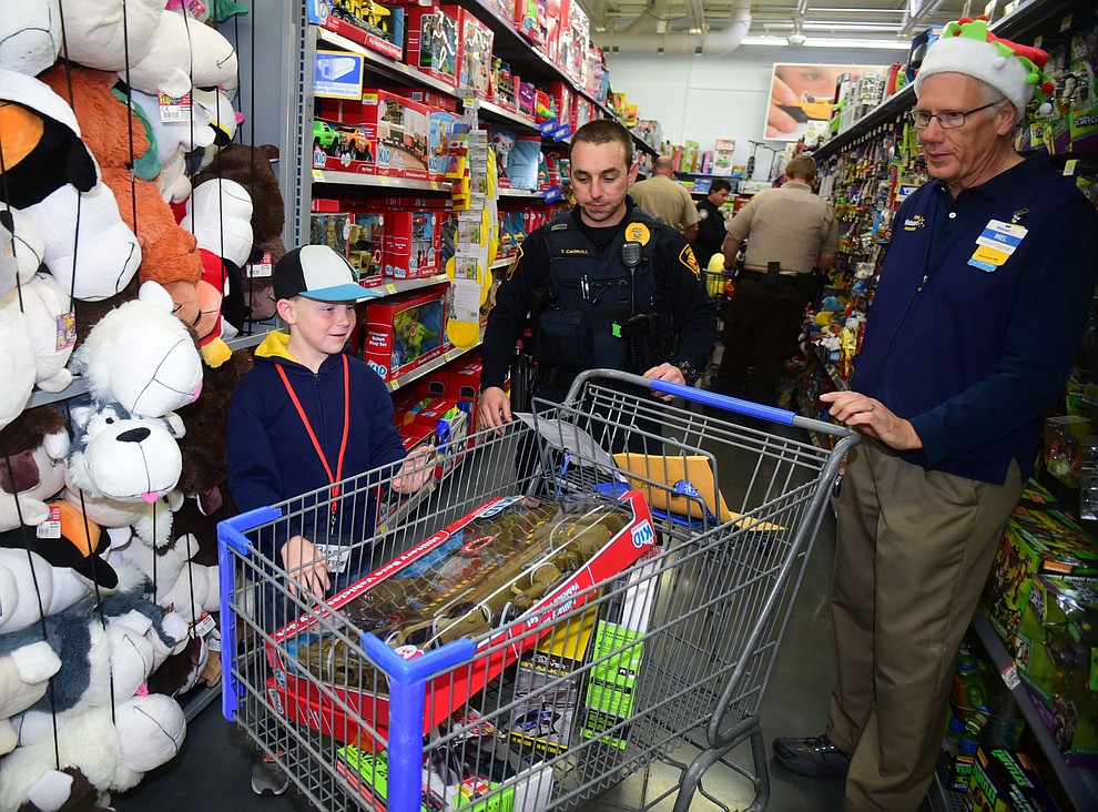 Law enforcement officers from 11 area agencies treated 91 children to a $250. shopping spree as part of the 19th Annual Shop with a Cop at the Prescott Valley Walmart Saturday, December 10.  (Les Stukenberg/The Daily Courier)
