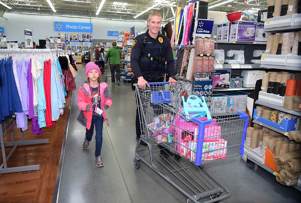 Law enforcement officers from 11 area agencies treated 91 children to a $250. shopping spree as part of the 19th Annual Shop with a Cop at the Prescott Valley Walmart Saturday, December 10.  (Les Stukenberg/The Daily Courier)
