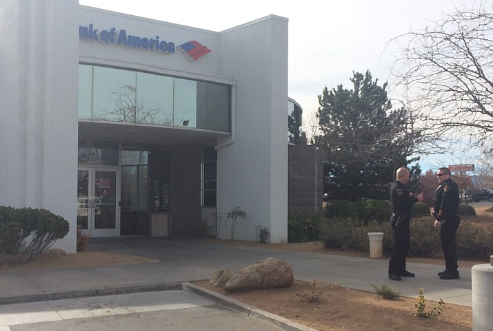 Prescott Valley police officers investigate one of two bank robberies allegedly attempted by the same man Monday Dec. 12
