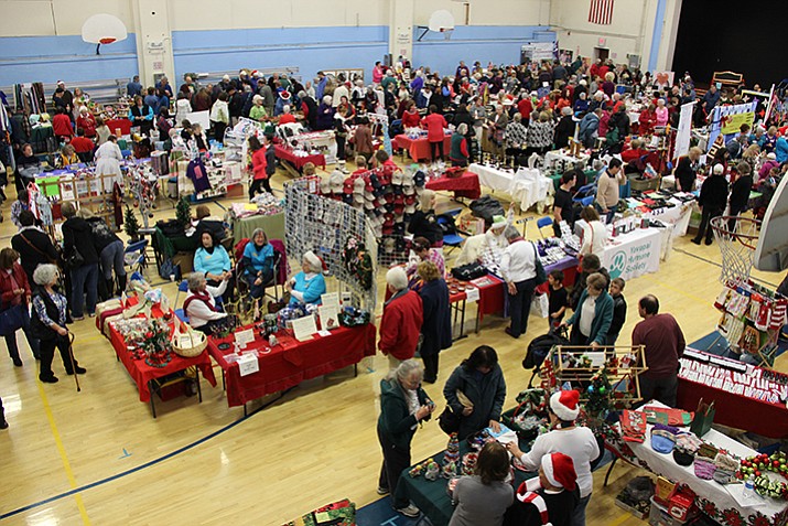 Shoppers peruse holiday gift items being sold by non-profit organizations at the Prescott Activity Center on Saturday, Dec. 17,  during the 25th annual Last-Minute Non-Profit Stocking-Stuffer Bazaar. 