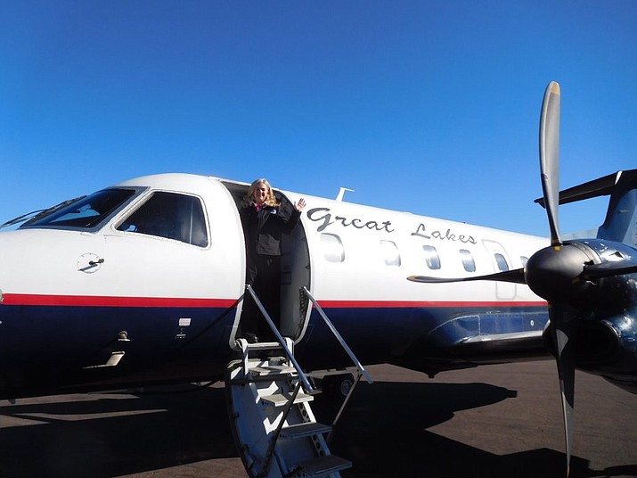Great Lakes Airlines attendant, Denver-based Jewell Stratton, welcomes passengers ready to board the inaugural Dec. 18 non-stop flight of the 30-passenger Brasilia turbo-prop from Prescott to Los Angeles International Airport. 