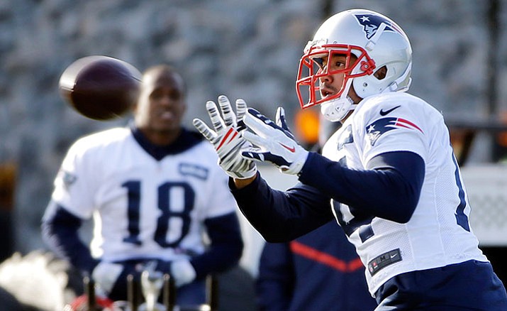 New England Patriots wide receiver Michael Floyd catches a pass as Matthew Slater (18) looks on during an NFL football team practice Wednesday, Dec. 21, in Foxborough, Mass.
