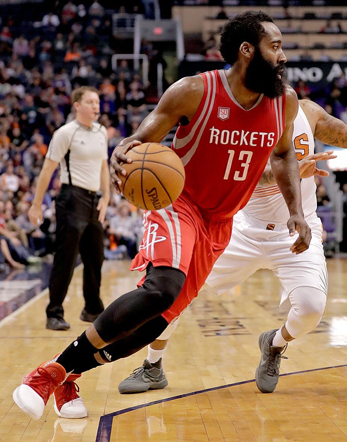 Houston Rockets guard James Harden (13) drives against the Phoenix Suns during the first half of an NBA basketball game, Wednesday, Dec. 21, in Phoenix.
