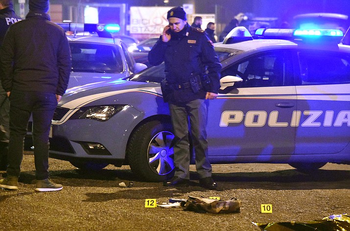 Italian police collect evidence after a shootout between police and a man near a train station in Milan's Sesto San Giovanni neighborhood, Italy, early Friday, Dec. 23, 2016. Italy's interior minister Marco Minniti says the man killed in an early-hours shootout in Milan is "without a shadow of doubt" the Berlin Christmas market attacker Anis Amri.