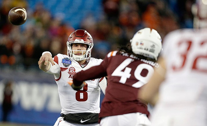 Arkansas’s Austin Allen (8) fires a pass off to teammate, Hayden Johnson (32), as Virginia Tech’s Tremaine Edmunds (49) defends during the first half of the Belk Bowl NCAA college football game in Charlotte, N.C., Thursday, Dec. 29.