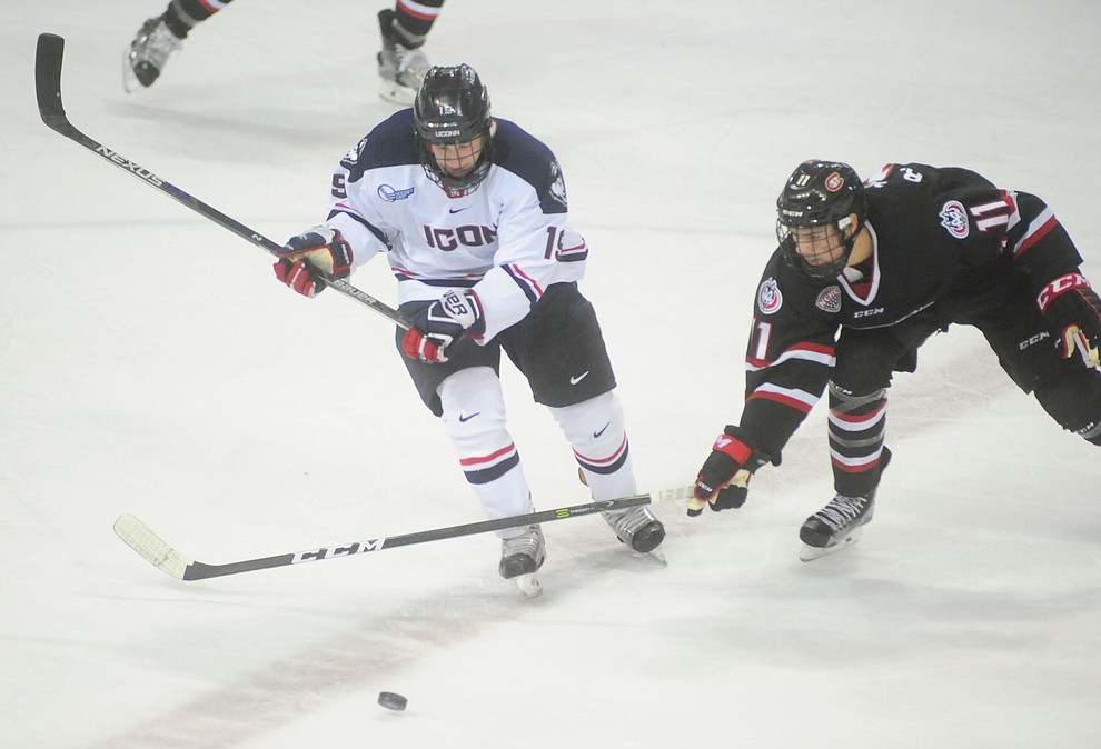 UConn's Evan Richardson and St Cloud's Ryan Poehling battle for the puck as the UConn Huskies take on the St Cloud State Huskies in the Desert Hockey Classic at the Prescott Valley Event Center Friday, December 30. (Les Stukenberg/The Daily Courier)