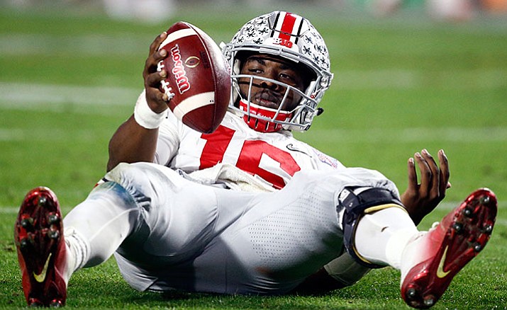 Ohio State quarterback J.T. Barrett looks to the sideline bench after being sacked by Clemson during the second half of the Fiesta Bowl NCAA college football playoff semifinal, Saturday, Dec. 31, in Glendale, Ariz. 