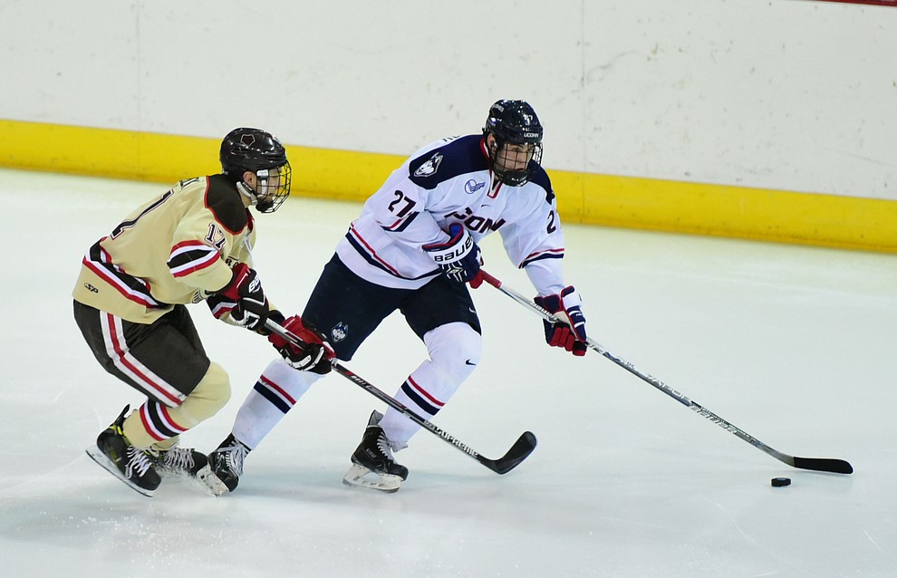 Brown's Zack Pryzbek pressures UConn's Maxim Letunov as the Bears from Brown University take on the UConn Huskies in the championship match of the Desert Hockey Classic at the Prescott Valley Event Center Saturday, December 31. (Les Stukenberg/The Daily Courier)