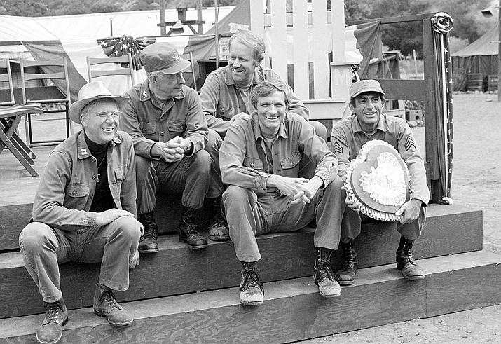 Cast members of the television series "M*A*S*H" from left, William Christopher, Harry Morgan, Mike Farrell, Alan Alda, and Jamie Farr, take a break on the set during taping in Los Angeles on Sept. 15, 1982. Christopher died Saturday, Dec. 31, 2016. He was 84.