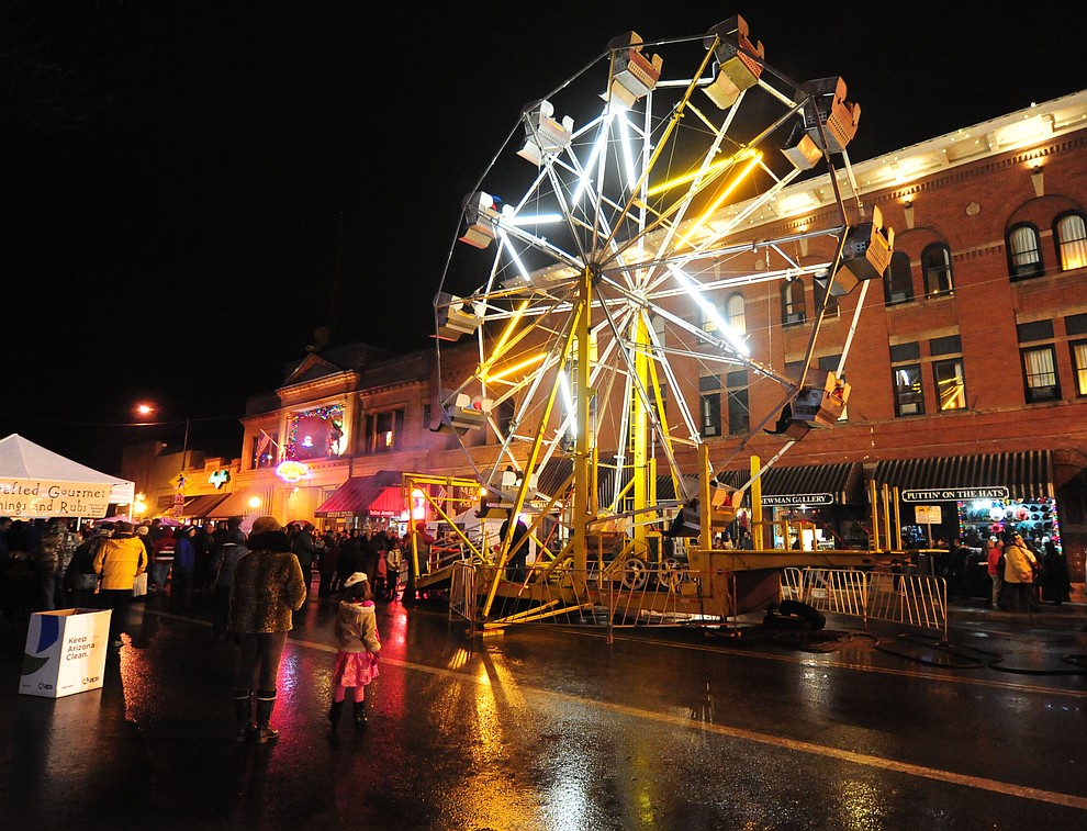 Despite the drizzle the ferris wheel runs at the 6th Annual Whiskey Row Boot Drop in downtown Prescott Saturday, Dec. 31. (Les Stukenberg/The Daily Courier)