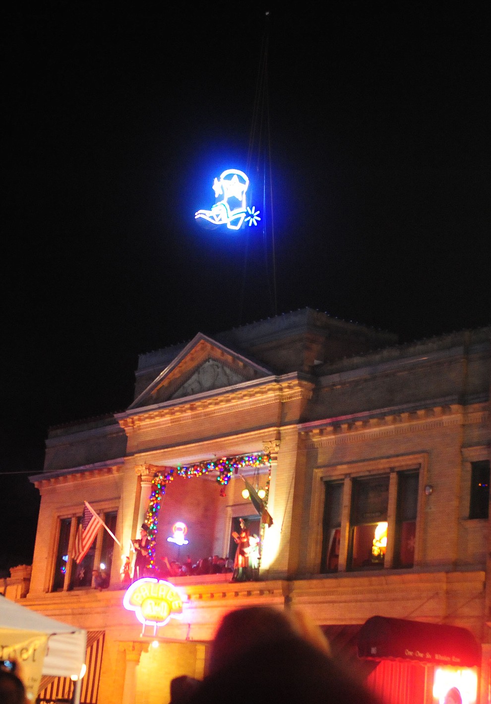 The boot lights up and drops down the flagpole at the 6th Annual Whiskey Row Boot Drop in downtown Prescott Saturday, Dec. 31. (Les Stukenberg/The Daily Courier)