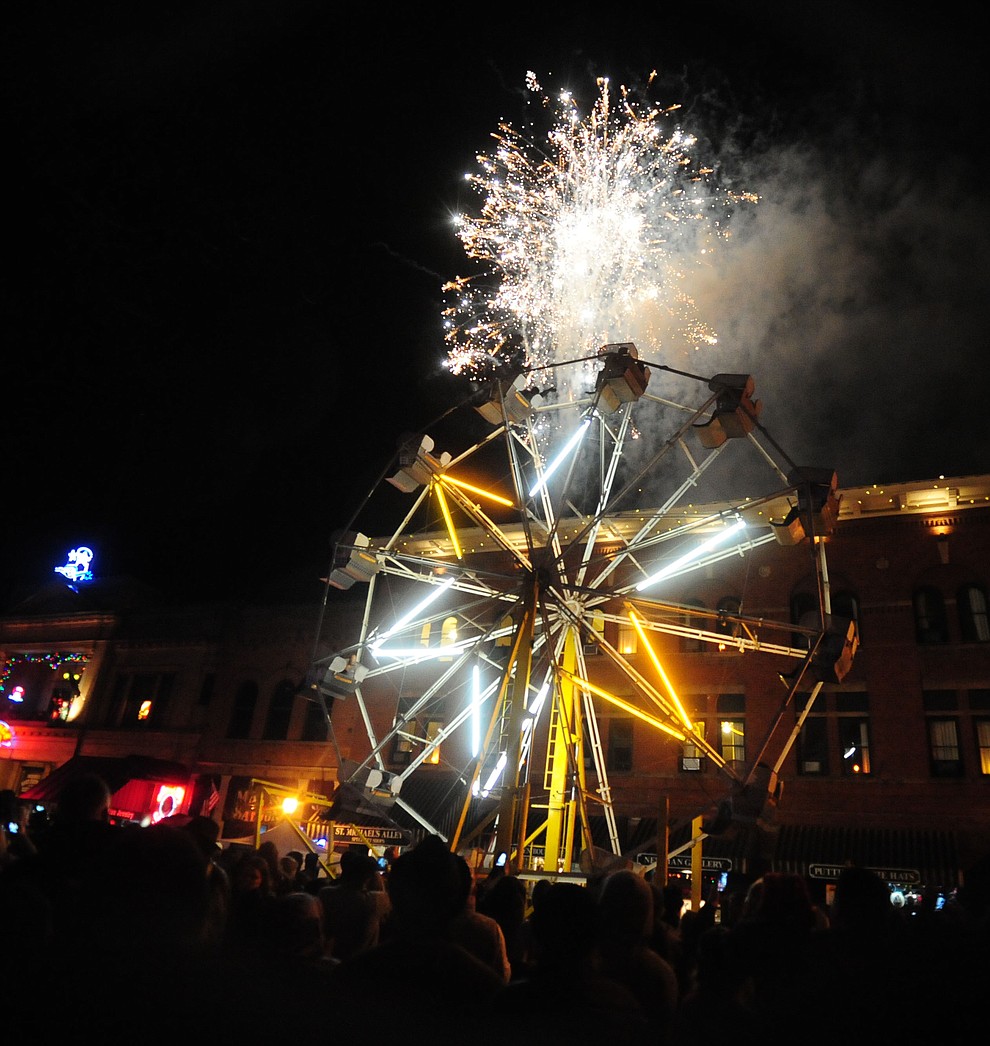 Fireworks erupt from the top of the parking garage at the 6th Annual Whiskey Row Boot Drop in downtown Prescott Saturday, Dec. 31, 2016.