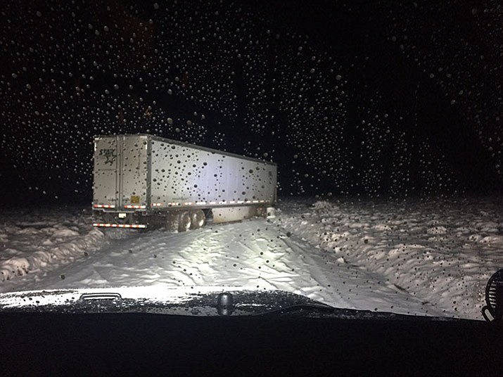 A semi tractor-trailer rig blocks Drake Road in the Christmas Eve snowstorm. Some drivers tried unsuccessfully to get past the truck, and they too got stuck.