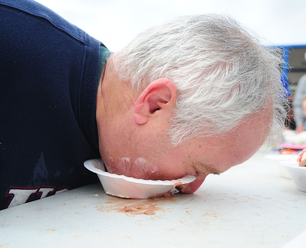 Bob Buse goes for the final bites in the ice cream eating contest during the 11th Annual Polar Bear Plunge at Mountain Valley Splash in Prescott Valley Saturday, January 7. (Les Stukenberg/The Daily Courier)