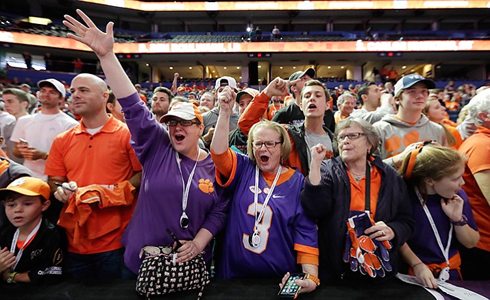 Clemson fans cheer during media day for the NCAA college football playoff championship game against Alabama Saturday, Jan. 7, in Tampa, Fla.