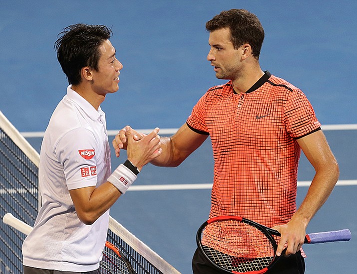 Grigor Dimitrov of Bulgaria, right, shakes hands with Kei Nishikori of Japan after beating him 6-2, 2-6, 6-3, in the final match at the Brisbane International tennis tournament in Brisbane, Australia, Sunday, Jan. 8. 

