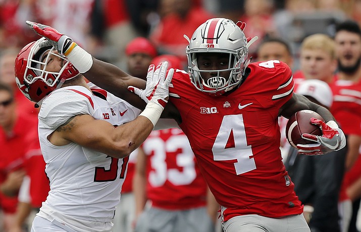 FILE - In this Oct. 1, 2016, file photo, Ohio State running back Curtis Samuel, right, stiff-arms Rutgers defensive back Anthony Cioffi during the first half of an NCAA college football game in Columbus, Ohio. Samuel is giving up his final year of eligibility to enter the NFL draft.
He posted a goodbye message on Twitter on Monday, Jan. 9, 2017. (AP Photo/Jay LaPrete, File)