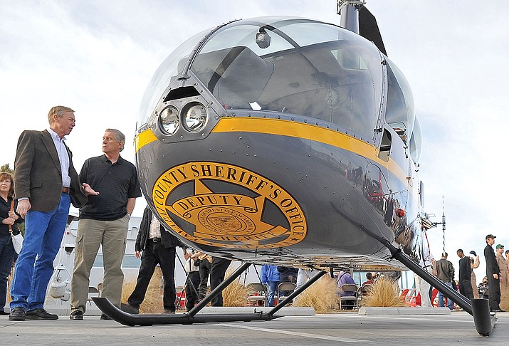 Former Yavapai County Sheriff Steve Waugh talks with Yavapai County Supervisor Tom Thurman about the YCSO’s R44 helicopter in 2012. The helicopter is operated at no taxpayer cost through RICO funds.