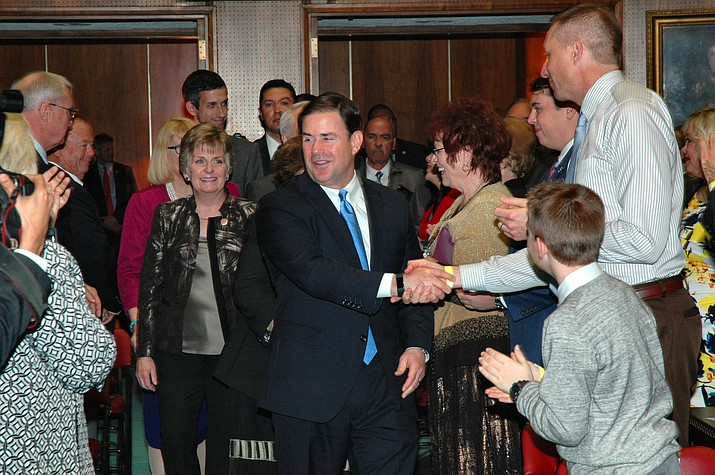 Gov. Doug Ducey greets lawmakers Monday as he arrives at the House for his State of the State speech.