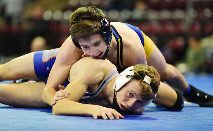 Prescott’s Darian Bowyer, top, battles during a semifinal round of the Mile High Challenge on Jan. 3. Bowyer pinned both of his opponents at the Roadrunner Multiple on Wednesday in Holbrook.