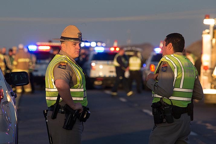 Emergency personnel gather at the scene where an Arizona Department of Public Safety trooper was shot, Thursday at the scene of a rollover accident on Interstate 10 near Tonopah, Ariz. 