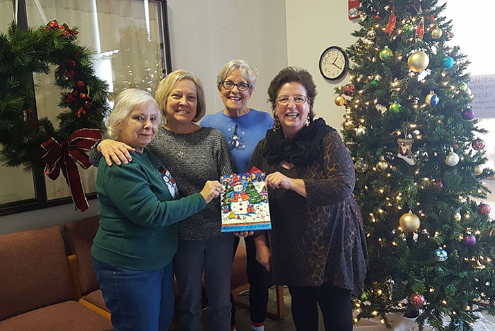 The Cliff Rose Ladies - Carole Strick, Gail Duarte and Nancy Brown - hand a gift bag containing the funds raised to Robin Burke of Stepping Stones.