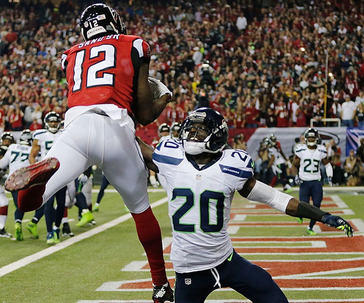 Atlanta Falcons wide receiver Mohamed Sanu makes a touchdown catch against Seattle Seahawks cornerback Jeremy Lane during their  divisional playoff game, Saturday, Jan. 14, in Atlanta.