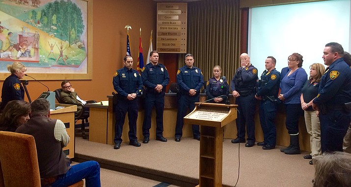 Prescott Police Chief Debora Black, left, presents a commendation to city police officers, detectives, and dispatchers who responded to a Dec. 3 potential active-shooter situation at the Highway 69 Wal-Mart in Prescott. Black says effective response by local police and dispatch employees prevented a mass-shooting tragedy.