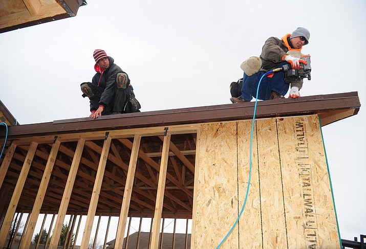  Daniel Cutter and Lorenzo Rangel of North Line Roofing work on a home in the Highlands Ranch subdivision of Chino Valley Friday, January 20. (Les Stukenberg/The Daily Courier)