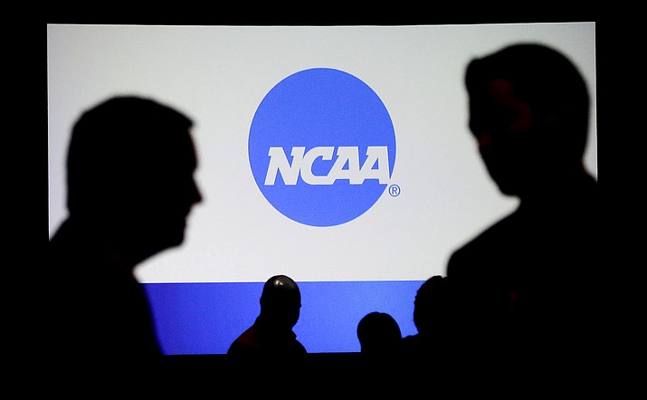 People talk after a panel discussion at the NCAA Convention on Thursday in Nashville, Tenn. The Power Five conferences voted Friday to stop coaches from taking teams off-campus for camps. (Mark Humphrey/Associated Press)
