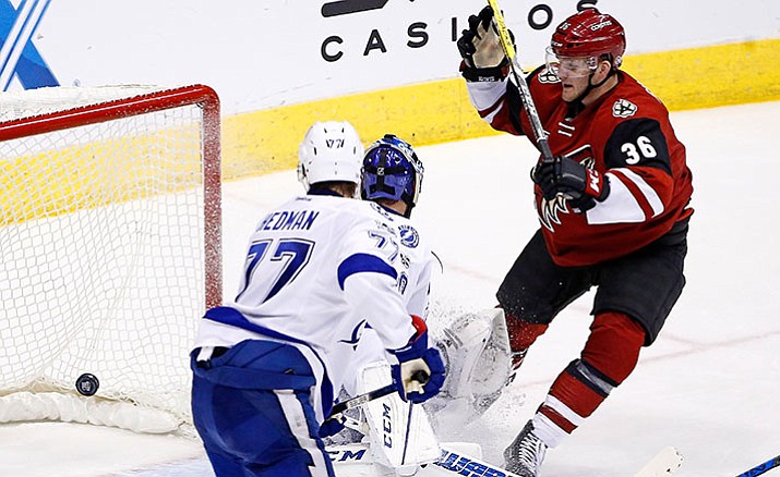 Arizona Coyotes right wing Christian Fischer (36) scores in his first NHL hockey game as the gets the puck past Tampa Bay Lightning defenseman Victor Hedman (77) and goalie Ben Bishop during the second period Saturday, Jan. 21, in Glendale.