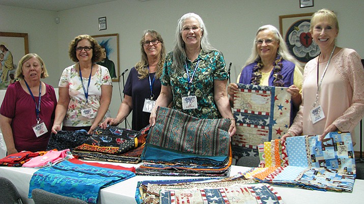 Virginia Promer, left, Patty McClearn, Marcy Raney, Sue McDonald, Linda Hill and Pattie Lascelle pose with the pillow cases they sewed during the American Sewing Guild’s 900 hours of sewing for charity during 2016.