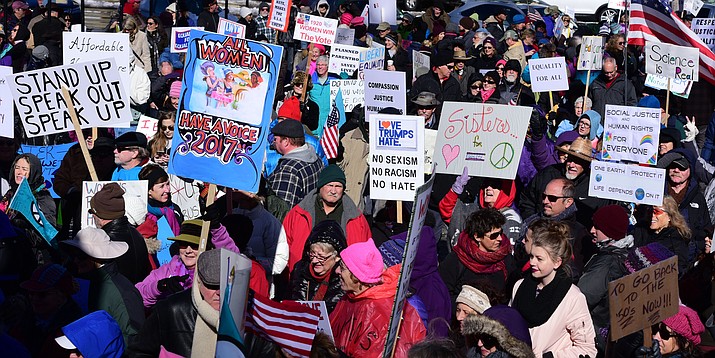 An estimated crowd of 1200 march in the Women's March around the Yavapai County Courthouse in Prescott Saturday, January 21. The march on the sidewalk wound completely around the courthouse plaza.  (Les Stukenberg/The Daily Courier)