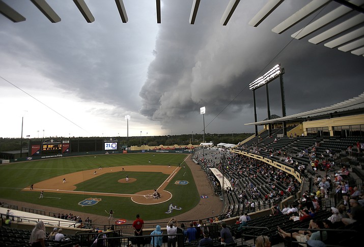 Storm clouds roll in over Champion Stadium in the seventh inning of a spring training baseball game between the Atlanta Braves and the Houston Astros on March 25, 2016, in Kissimmee, Fla. Moments later the game was stopped because of rain. (John Raoux/Associated Press, File)