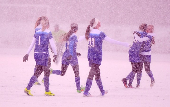 Prescott players celebrate the win in snowy conditions as the Badgers played the Bradshaw Mountain in a cross-town rivalry soccer game Tuesday in Prescott Valley. (Les Stukenberg/The Daily Courier)