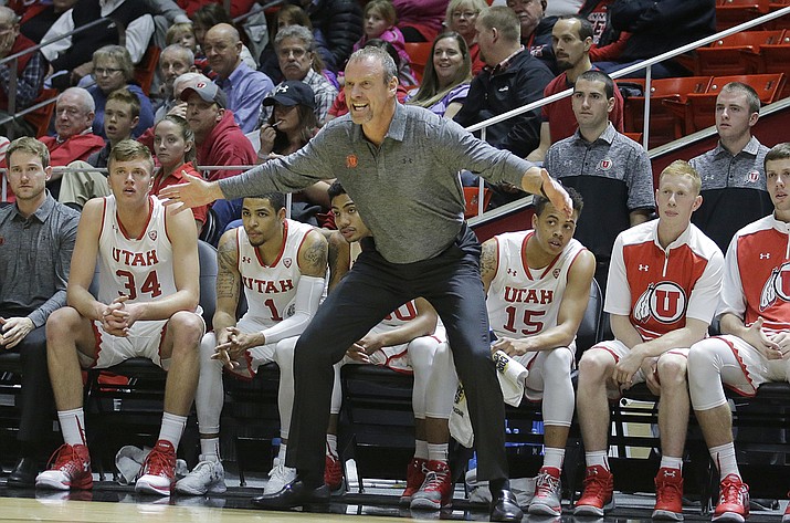 FILE - In this Jan. 1, 2017, file photo, Utah coach Larry Krystkowiak shouts to his team during the first half of an NCAA college basketball game against Colorado in Salt Lake City. Utah is exceeding expectations after being picked to finish eighth in the Pac-12. The Utes received their first vote in the AP Top 25 poll this week and sit fourth in the conference standings, behind No. 8 UCLA, No. 7 Arizona and No. 10 Oregon. (AP Photo/Rick Bowmer, File)