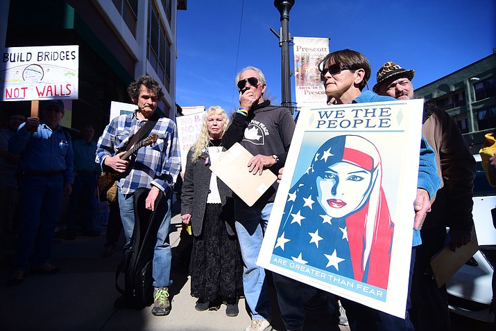Approximately 75 protesters gather outside the Prescott offices of Senator John McCain and Congressman Paul Gosar to protest some of the decisions that President Donald Trump has recently announced. (Les Stukenberg/The Daily Courier)