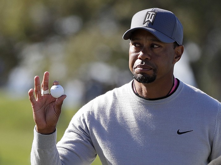 Tiger Woods reacts to the crowd after finishing the 11th hole of the North Course during the second round of the Farmers Insurance Open golf tournament Friday, Jan. 27, at Torrey Pines Golf Course in San Diego. (Gregory Bull/Associated Press)