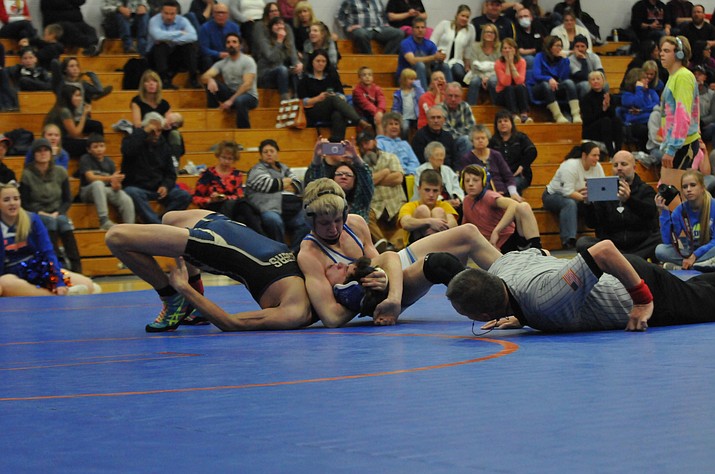 Chino freshman Keller Rock defeats Prescott High’s Koby Coates in a 138-pound match. 