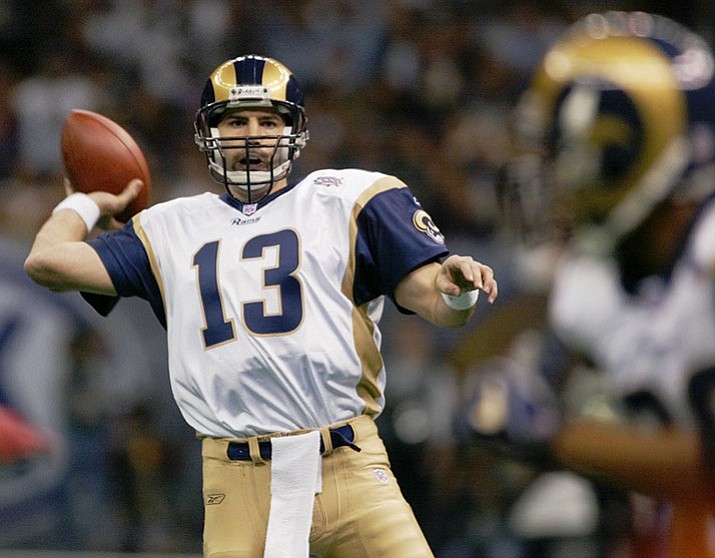 In this Feb. 3, 2002, file photo, St. Louis Rams quarterback Kurt Warner looks to pass to Marshall Faulk, right, in the first quarter against the New England Patriots in Super Bowl 36 in New Orleans. Warner is part of seven-man class heading into the Pro Football Hall of Fame, it was announced Saturday, Feb. 4, 2017. 

