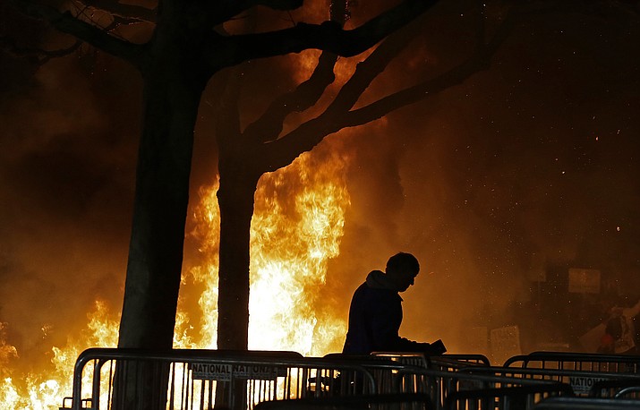 A bonfire set by demonstrators protesting a scheduled speaking appearance by Breitbart News editor Milo Yiannopoulos burns on Sproul Plaza on the University of California at Berkeley campus on Wednesday, Feb. 1, in Berkeley, Calif.