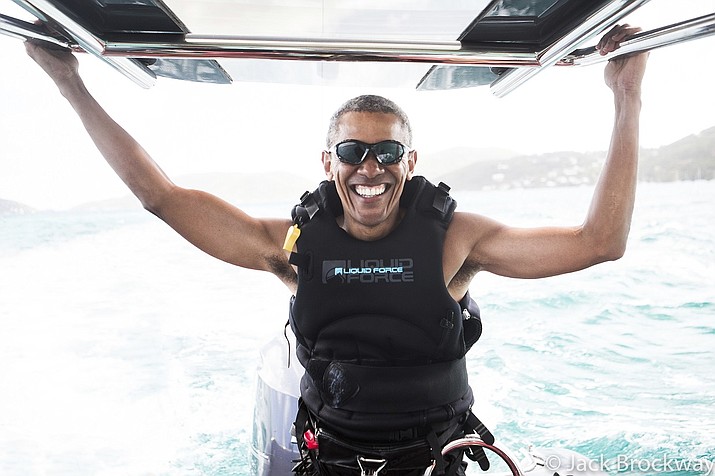 Former U.S President Barack Obama prepares to kitesurf during his stay on a private island in the British Virgin Islands. The former president and his wife stayed on Mosikto Island owned by billionaire Richard Branson, founder of the Virgin Group.