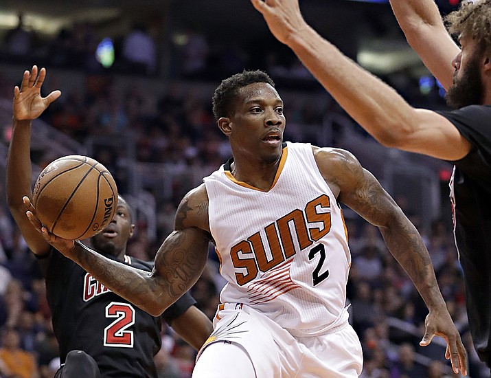 Phoenix Suns guard Eric Bledsoe (2) passes as Chicago Bulls center Robin Lopez, right, and guard Jerian Grant, rear, defend during the second half of an NBA basketball game, Friday, Feb. 10, in Phoenix. (Matt York/Associated Press)