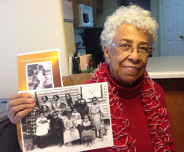 Aaronetta Edmunds holds the photos of her grandparents (Robert and Edith Brooks and their children taken in 1898.