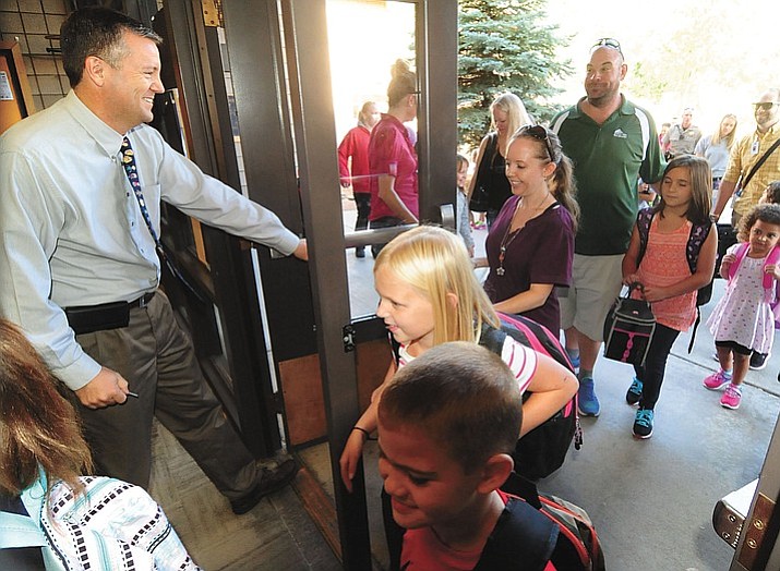 In this August 2016 file photo Principal Clark Tenney opens the doors for the first day of the 2016-17 school year at Abia Judd Elementary School in Prescott. Arizona voters continue to ask that our legislature fully fund public education, knowing that schools are the linchpin to a strong society.