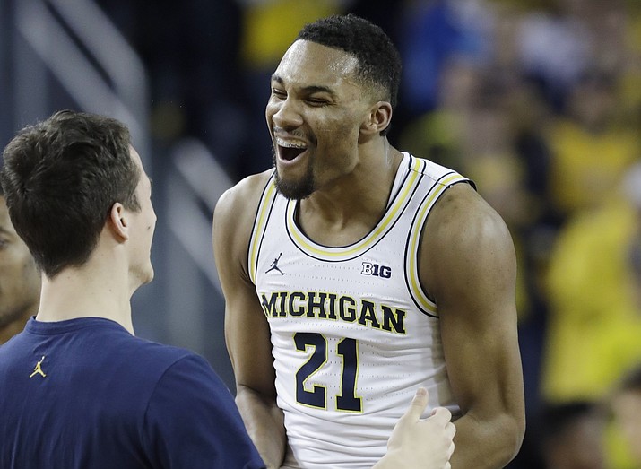 Michigan guard Zak Irvin (21) reacts after a 3-point basket during the first half Thursday, Feb. 17, against Wisconsin in Ann Arbor, Mich. (Carlos Osorio/Associated Press)