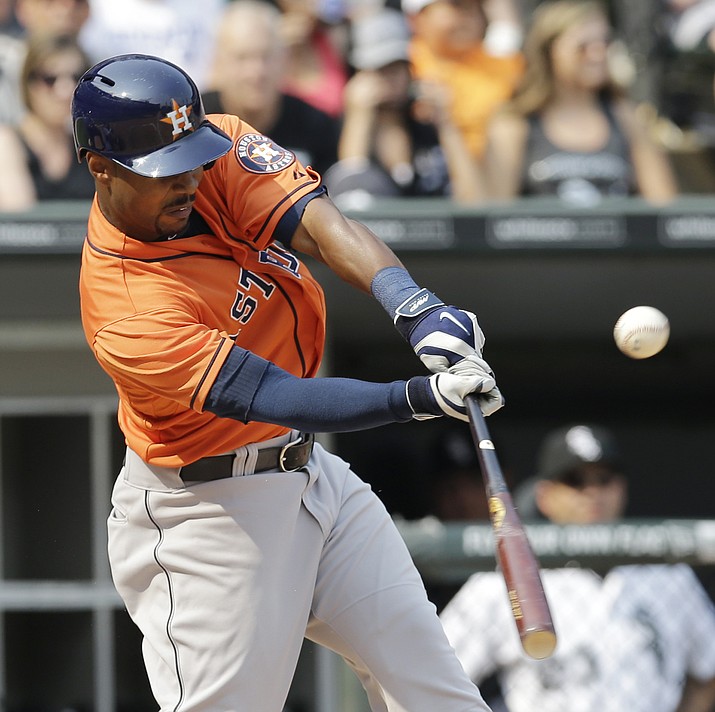 In this July 20, 2014, file photo, Houston Astros’ L.J. Hoes hits an one-run double against the Chicago White Sox during the seventh inning of a baseball game in Chicago. Former big league outfielder Hoes has been suspended for 50 games under baseball’s minor league drug program following a second positive test for a drug of abuse.