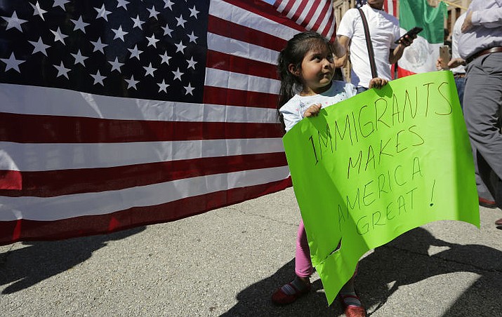 Yaretzi Perez, 4, holds a sign as she joins her family and others during a march and rally during an immigration protest, Thursday, Feb. 16, 2017, in Austin, Texas. Immigrants around the U.S. stayed home from work and school Thursday to demonstrate how important they are to America's economy and its way of life, and many businesses closed in solidarity, in a nationwide protest called A Day Without Immigrants.