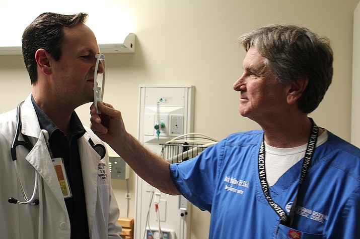 Mark Hopkins, right, measures the nose of Dr. Haven Malish, director of the KRMC Sleep Center. Hopkins uses self-hypnosis to help patients with sleeping disorders. The center recently expanded to six beds at KRMC’s Hualapai Mountain Campus.